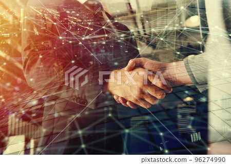 Handshaking business person in office with network effect. concept of teamwork and partnership. double exposure 96274990