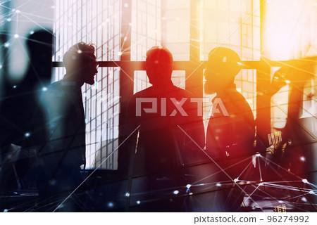 Businessmen that work together in office with network connection effect. Concept of teamwork and partnership. double exposure 96274992