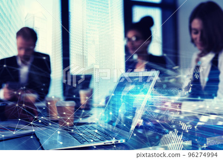 Teamwork works with a laptop. Concept of internet sharing and interconnection. double exposure 96274994