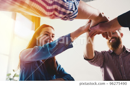 Business people putting their hands together. Concept of teamwork and partnership 96275490