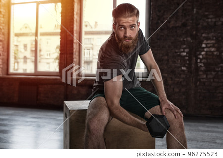 Athletic man training biceps at the gym Athletic man training biceps at the gym 96275523