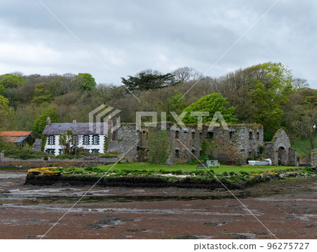 The Arundel grain store on the shore of Clonakilty Bay in the spring. An old stone building in Ireland, Europe. Historical architectural monument, landscape. Tourist attractions in Ireland 96275727