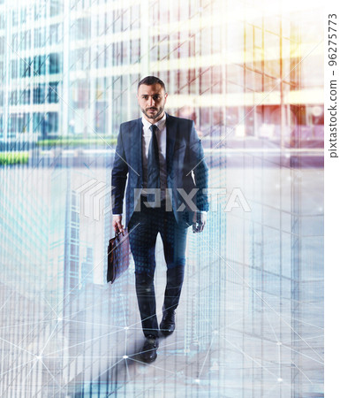 Determinated businessman walking in the city. double exposure 96275773