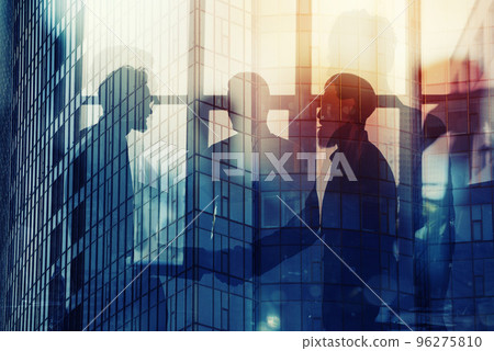 Handshaking business person in office. concept of teamwork and partnership. double exposure 96275810