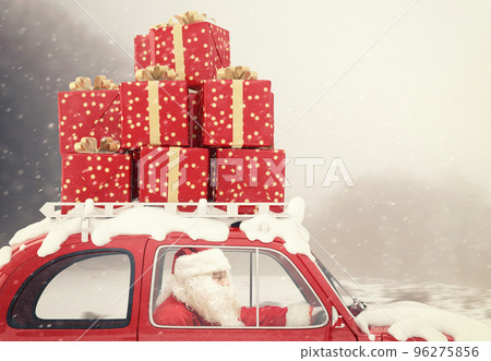 Santa Claus on a red car full of Christmas present 96275856