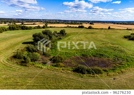 Waterlogged and tree-covered river oxbow in the field 96276230