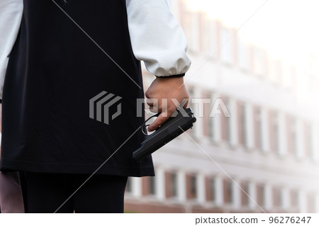Firearms at school. A teenager with a gun on the background of the school. The girl goes to school with a gun. School violence Firearms at school. A teenager with a gun on the background of the school. The girl goes to school with a gun. School violence 96276247