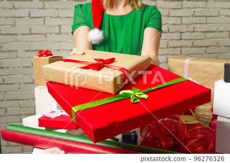 Female hands holding packed present for christmas Festive backdrop for holidays Birthday, Valentines day, Christmas, New Year. packing service concept 96276326