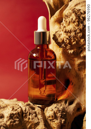The bottle is brown on a burgundy background. The bottle is brown on a burgundy background. 96276990