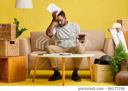 Man having headache when trying to manage his personal finances Man having headache when trying to manage his personal finances 96277296