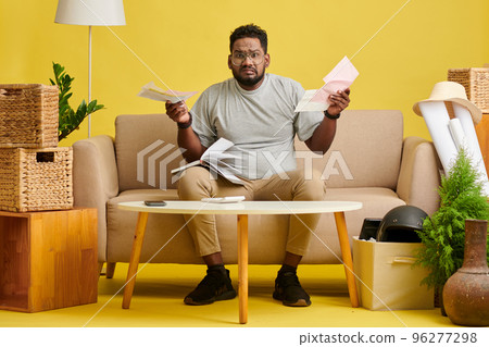 Unhappy man unable to manage personal finances and pay bills and loan Unhappy man unable to manage personal finances and pay bills and loan 96277298