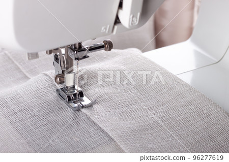 Modern sewing machine presser foot and item of clothes. Sewing process, handmade, hobby, business 96277619