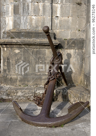 Large antique ship anchor leaning against the wall Large antique ship anchor leaning against the wall 96278146