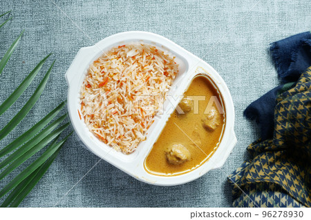 curry chicken and rice in a take away plastic packet on table  96278930