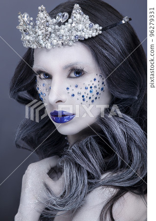 Snow Queen.Fantasy girl portrait. Winter fairy portrait.Young woman with creative silver artistic make-up. 96279331