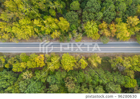 Aerial view from above of country road through the green summer forest in Autumn, Broken Bow, Oklahoma, USA. Drone photography Aerial view from above of country road through the green summer forest in Autumn, Broken Bow, Oklahoma, USA. Drone photography 96280630