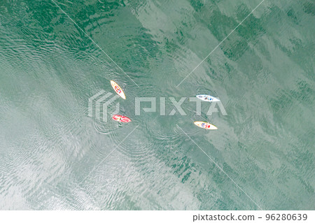 Aerial top down view of sport canoes rowing on the Broken Bow lake, Oklahoma, USA. Kayaking on lake, photo from drone. Aerial top down view of sport canoes rowing on the Broken Bow lake, Oklahoma, USA. Kayaking on lake, photo from drone. 96280639