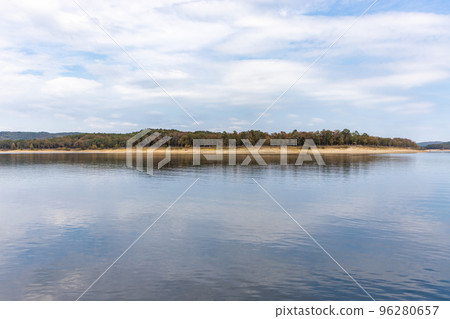 Beautiful landscape with blue sky and smooth lake surface, forest and coastline in the distance, Broken bow lake, Oklahoma , USA. Beautiful landscape with blue sky and smooth lake surface, forest and coastline in the distance, Broken bow lake, Oklahoma , USA. 96280657