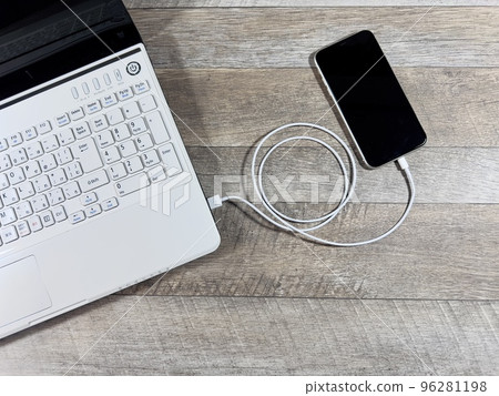 Laptop and smartphone data transfer bird's eye view Laptop and smartphone data transfer bird's eye view 96281198