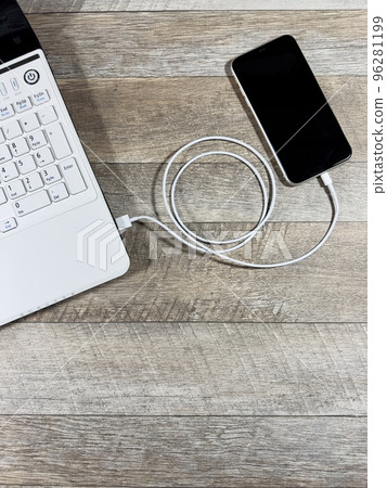 Laptop and smartphone Data transfer Vertical position Bird's eye view Laptop and smartphone Data transfer Vertical position Bird's eye view 96281199