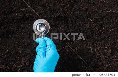 Hand of researcher woman wear gloves holding a stethoscope on fertile black soil for check condition before agriculture or planting, Concept of World Soil Day, Earth day and hands ecology environments 96281703