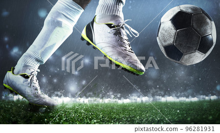 Close up of a soccer scene with player kicking the ball with power 96281931