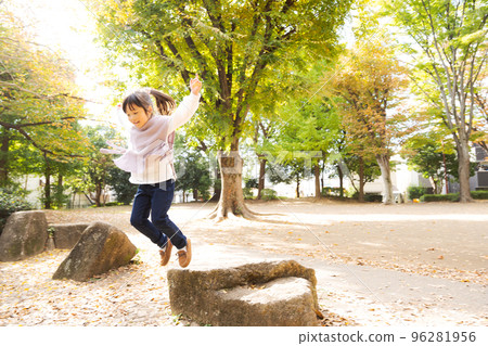Energetic girl playing in the park 96281956