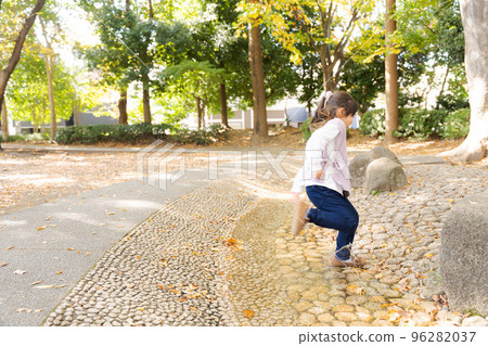 Energetic girl playing in the park Energetic girl playing in the park 96282037