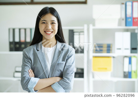 Close up Portrait of confident woman arms crossed smiling at camera. 96282096