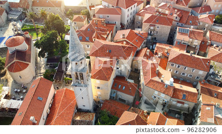 Panoramic sunset aerial drone view of ancient city of Budva, Montenegro. Old medieval town with red roofs. Kotor bay, coast of Adriatic sea. Budva is most popular resort town in Montenegro Panoramic sunset aerial drone view of ancient city of Budva, Montenegro. Old medieval town with red roofs. Kotor bay, coast of Adriatic sea. Budva is most popular resort town in Montenegro 96282906