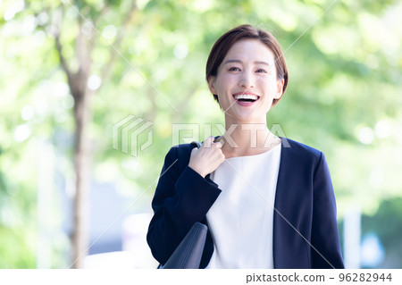 Business portrait of a woman walking outside 96282944
