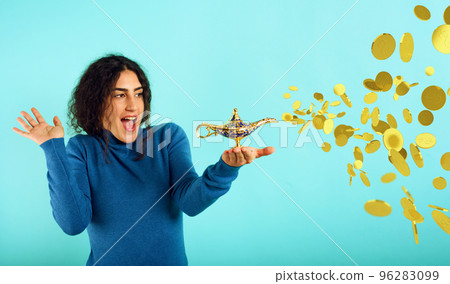 Woman is happy becaouse she founds lamp of aladdin and asked for money. Cyan background Woman is happy becaouse she founds lamp of aladdin and asked for money. Cyan background 96283099