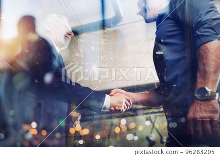 Handshaking business person in office. concept of teamwork and partnership. Handshaking business person in office. concept of teamwork and partnership. 96283205