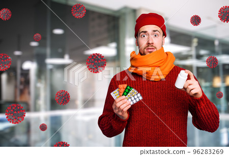 Boy caught a cold and uses pills to heal. Studio on Cyan background 96283269