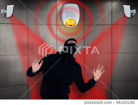 Thief with balaclava was spotted trying to steal in a apartment from the security alarm system. Scared expression Thief with balaclava was spotted trying to steal in a apartment from the security alarm system. Scared expression 96283288