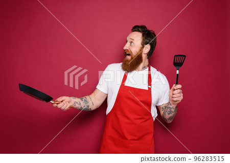 Happy chef cooks a new creative recipe. red background Happy chef cooks a new creative recipe. red background 96283515