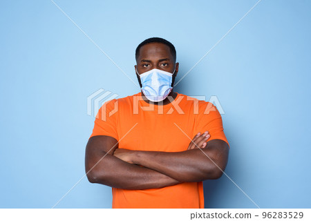 Man with face mask has a lot of questions and doubts about covid 19. cyan background Man with face mask has a lot of questions and doubts about covid 19. cyan background 96283529