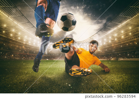 Close up of a football action scene with competing soccer players at the stadium 96283594