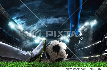 Close up of a football action scene with competing soccer players at the stadium 96283610