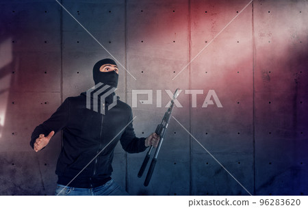 Thief with balaclava and wire cutter was spotted trying to steal in a apartment from the security alarm system. Scared expression Thief with balaclava and wire cutter was spotted trying to steal in a apartment from the security alarm system. Scared expression 96283620