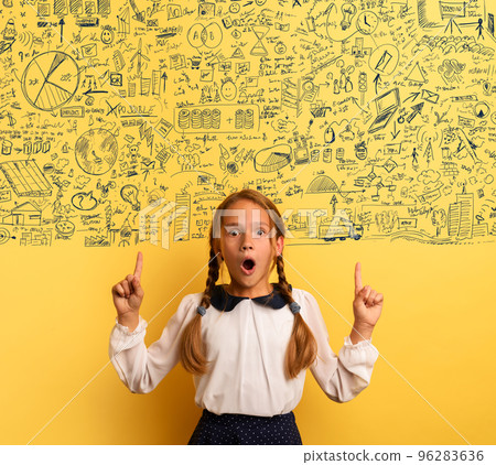 Young student is with shocked expression and indicates a complex exercise. Yellow background Young student is with shocked expression and indicates a complex exercise. Yellow background 96283636