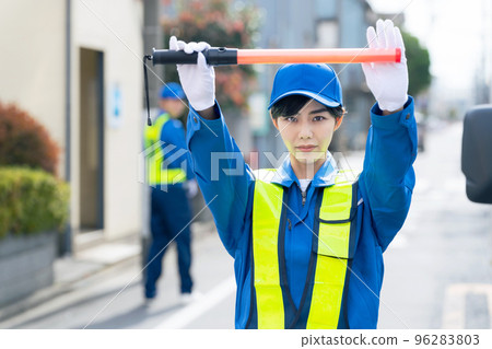 security guard blocking traffic 96283803