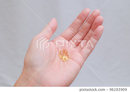 Supplement pills in the palm of your hand 96283909