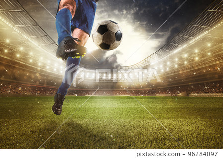 Close up of a striker who kicks the ball to make goals at the stadium during a soccer game 96284097