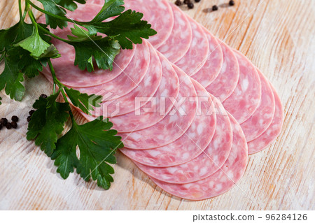 Catalan sausage slices on wooden background Catalan sausage slices on wooden background 96284126