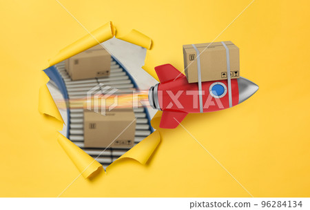 Carton box flies fast with rocket. concept of express and priority delivery Carton box flies fast with rocket. concept of express and priority delivery 96284134