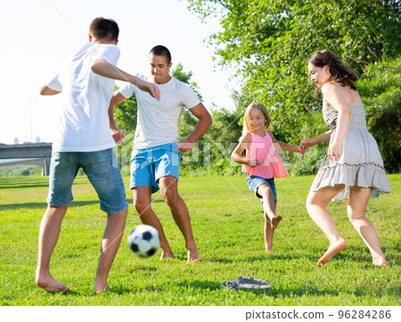 Happy family playing football 96284286