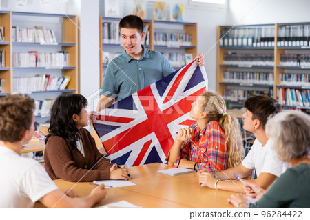 European student guy holding the national flag of Great Britain in her hands 96284422