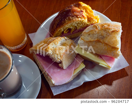 Delicious sandwiches with ham and cheese 96284717