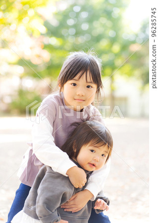 Sisters playing with each other 96285745